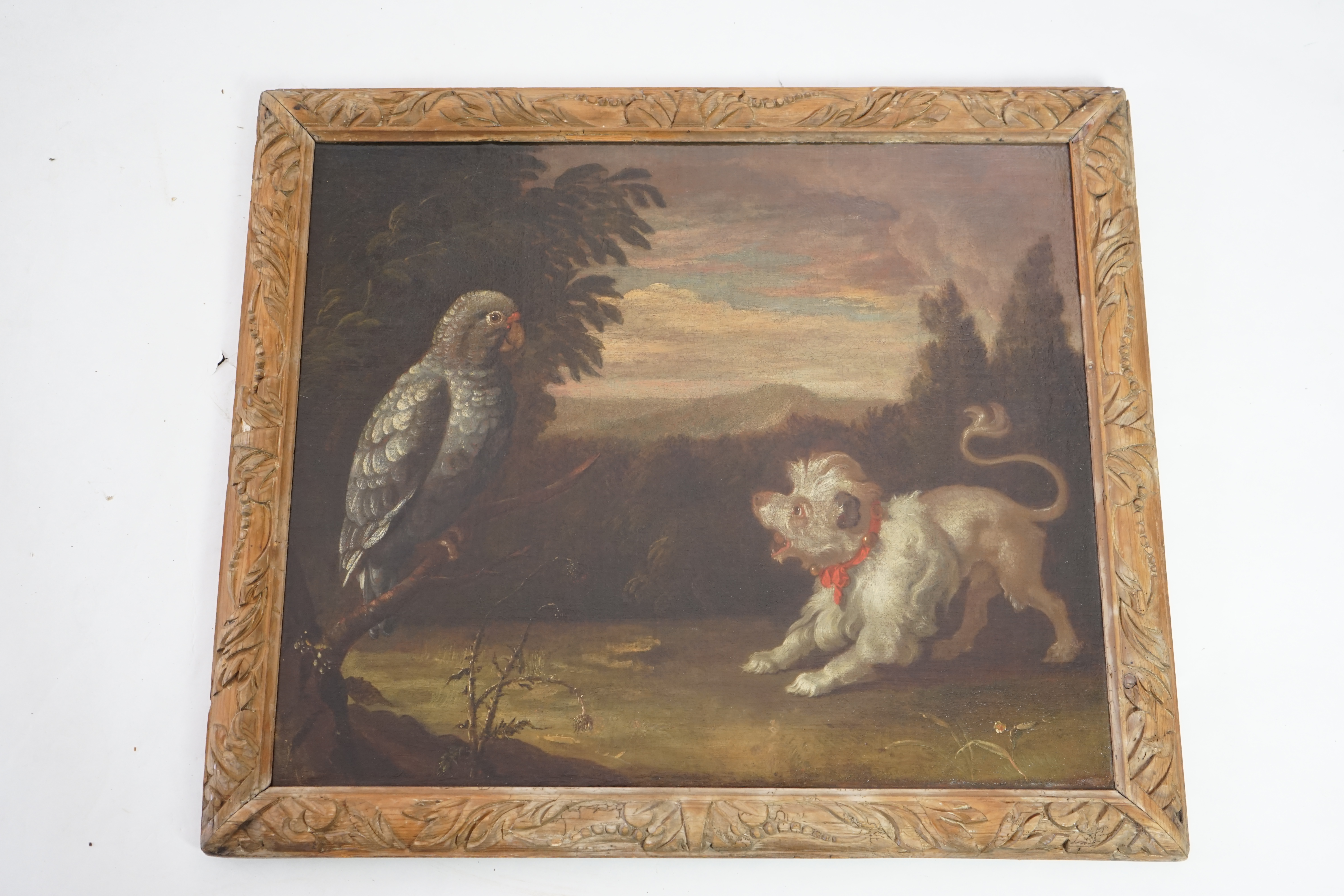 Circle of Francis Barlow (British, 1624-1724), Lion-dog and a grey parrot in landscape, oil on canvas, 62 x 74cm